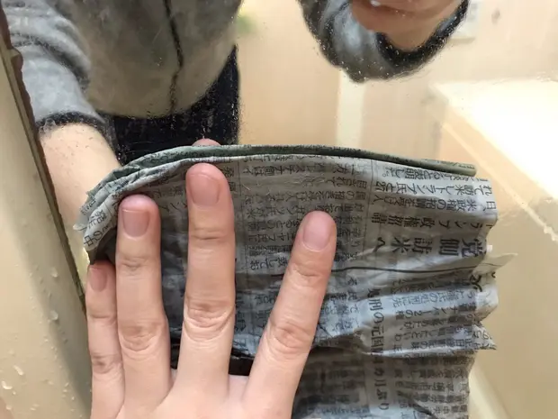 鏡を濡らした新聞紙で拭く