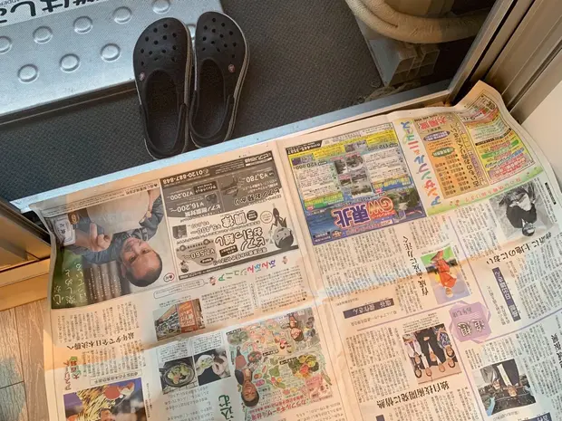 網戸の下に新聞紙を貼って養生している