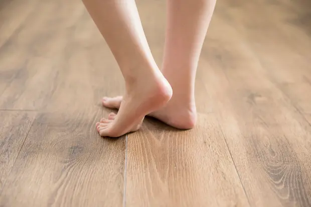 フローリングを裸足で歩く画像